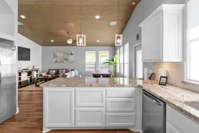 Bright, open-concept kitchen with plenty of counter space—perfect for cooking, gathering, and staying connected with everyone in the living room.