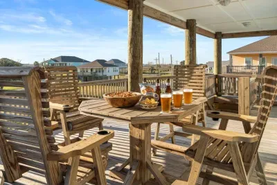 Unwind on the spacious covered deck with plenty of seating for the whole group. It’s the perfect spot for morning coffee, afternoon snacks, or a laid-back evening drink while you take in the coastal breeze and neighborhood views.