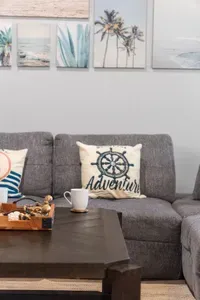 Kick back in the cozy living room with beachy decor and plenty of space to relax—perfect for morning coffee, family time, and unwinding after a day on the sand.