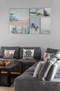 Kick back in the cozy living room with plenty of seating, beachy decor, and space for everyone to relax after a day in the sun.