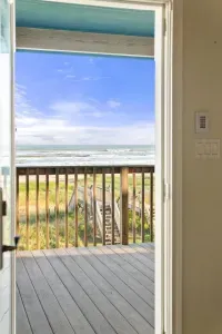 Enjoy breathtaking sunrises and the soothing sound of ocean waves from the front porch deck. Spend your days on the beach, easily accessed via your private walkway leading directly to the sand and surf.
