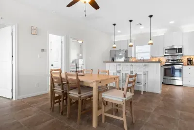 Dining room table with chairs for 6 plus 3 more stools for seating at the island give ample room for everyone to sit down for your meals.