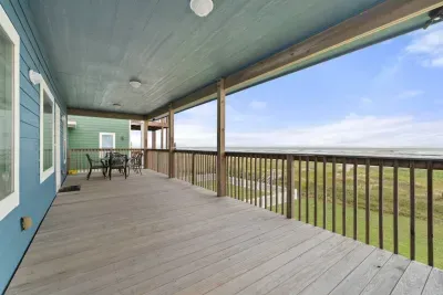 Enjoy breathtaking sunrises and the soothing sound of ocean waves from the front porch deck. Spend your days on the beach, easily accessed via your private walkway leading directly to the sand and surf.