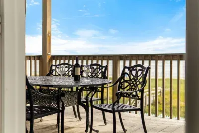 Enjoy breathtaking sunrises and the soothing sound of ocean waves from the front porch deck. Spend your days on the beach, easily accessed via your private walkway leading directly to the sand and surf.