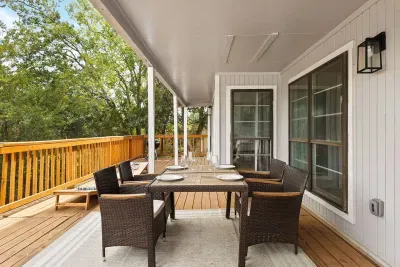 Relax and unwind on the expansive covered deck, complete with comfortable outdoor seating and stunning treetop views. Whether you're sipping your morning coffee or enjoying dinner, this spacious deck offers privacy and scenery for a peaceful getaway.