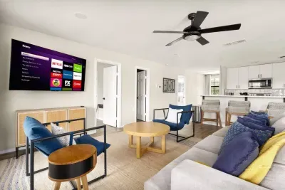Bright and inviting, this open-concept living room sits right next to the kitchen, offering scenic views, cozy seating, and a warm space to gather for movies, games, or family time after a day at the lake.