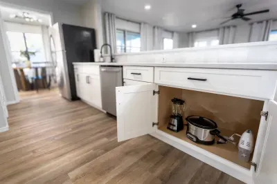 Everything you need at your fingertips! Open drawers reveal a variety of kitchen essentials, perfect for preparing delicious meals, baking treats, or whipping up your favorite desserts during your stay.