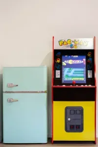 Game on! Enjoy endless fun with classic arcade games right in the cozy living room, perfect for family battles and late-night laughs, with a handy mini fridge nearby to keep your drinks chilled and ready for every round.