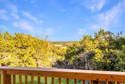 Relax on your private balcony with sweeping Hill Country views. Surrounded by cedar and oak trees, you’ll enjoy privacy and a glimpse of the shimmering lake in the distance, the perfect backdrop for coffee, wine, or quiet relaxation.