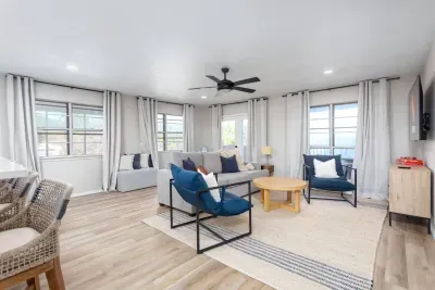 Bright and inviting, this Canyon Lake living room features scenic views, cozy seating, and coastal-inspired décor, perfect for relaxing after a day on the lake or gathering for movies, games, and memorable moments with family and friends.