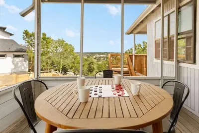 Step outside and relax! This covered deck features a 4-seat round table, perfect for morning coffee, board games, or simply enjoying the fresh mountain air and scenic views at Mountain Top Retreat.