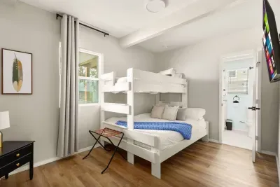 Bright, family-friendly room with full-over-twin bunk beds, cozy bedding, and smart TV. Includes a private en-suite bathroom for added convenience, making it perfect for kids or extra guests.