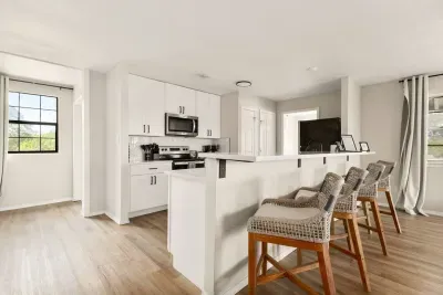 Gather around! This spacious kitchen counter features four high chairs, making it the perfect spot for casual meals, morning coffee, or chatting while cooking, all with scenic views just steps away.