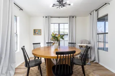 Enjoy every meal with a view! This 6-seater round dining table is surrounded by large glass windows, letting in natural light and offering stunning scenic views, perfect for family dinners, game nights, or relaxing meals.