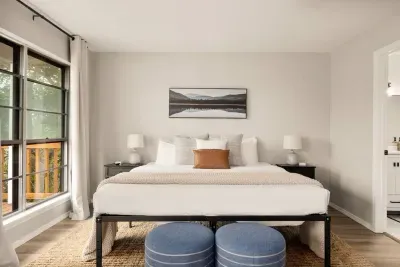 Spacious Canyon Lake bedroom with a king bed, serene décor, and private deck access. Enjoy morning coffee with nature views, unwind in comfort, and sleep soundly after a day of lake adventures.