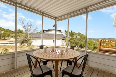 Step outside and relax! This covered deck features a 4-seat round table, perfect for morning coffee, board games, or simply enjoying the fresh mountain air and scenic views at Mountain Top Retreat.