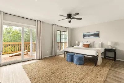 Spacious Canyon Lake bedroom with a king bed, serene décor, and private deck access. Enjoy morning coffee with nature views, unwind in comfort, and sleep soundly after a day of lake adventures.