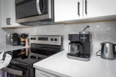 Bright and modern, this kitchen showcases sleek white cabinets, a gas range, microwave, and all the essentials, from cookware to spices. The open layout makes it easy to cook, chat, and connect while enjoying the cozy charm of Mountain Top Retreat.