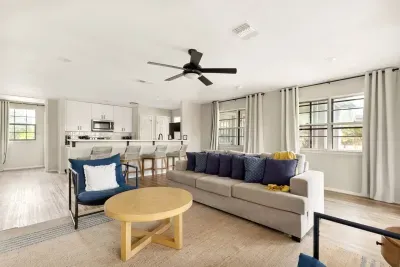 Bright and inviting, this open-concept living room sits right next to the kitchen, offering scenic views, cozy seating, and a warm space to gather for movies, games, or family time after a day at the lake.