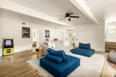 Kick back in the ultimate living room, featuring plush lounge seating, retro arcade game, and fun movie posters. With space for the whole crew, this cozy hangout spot is perfect for family game nights, entertainment, or relaxing after a day of fun.