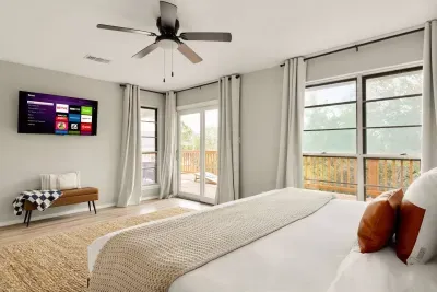 Spacious Canyon Lake bedroom with a king bed, serene décor, and private deck access. Enjoy morning coffee with nature views, unwind in comfort, and sleep soundly after a day of lake adventures.