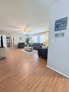 The living room features a cozy setup with a couch, loveseat, oversized chair, and a coffee table. Enjoy entertainment on the 50” Roku TV, and for some unplugged fun, board games and puzzle books can be found inside the coffee table.