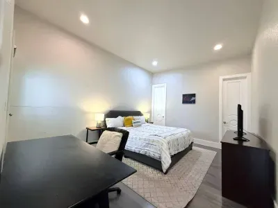 The spacious master bedroom is your private retreat, complete with a comfy bed, work-friendly desk and chair, and a Smart TV for winding down. Whether you're working remotely or just relaxing, this room has you covered.