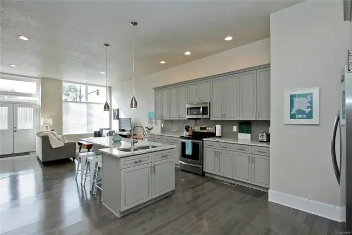 The kitchen opens right into the living room, making it easy to cook, chat, and stay connected, whether you're whipping up dinner or just grabbing a snack.