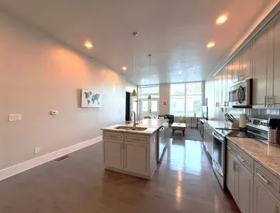 The kitchen opens right into the living room, making it easy to cook, chat, and stay connected, whether you're whipping up dinner or just grabbing a snack.