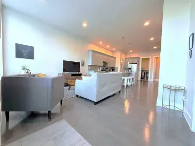 Cozy and open, this living room flows right into the kitchen, making it easy to relax, hang out, or cook up something tasty.