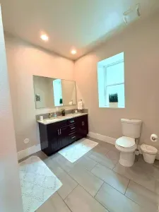Fresh, clean, and functional, this full bathroom features a spacious bathtub, perfect for a relaxing soak after a long day, plus all the essentials to keep you feeling at home.