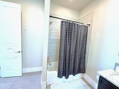 Fresh, clean, and functional, this full bathroom features a spacious bathtub, perfect for a relaxing soak after a long day, plus all the essentials to keep you feeling at home.