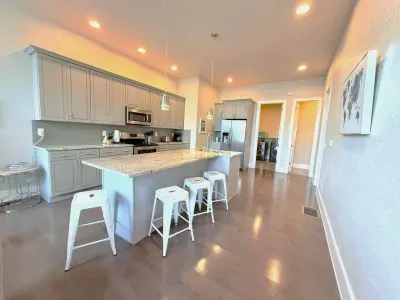 This modern kitchen has everything you need, with a spacious island that doubles as a dining table, perfect for meals, morning coffee, or catching up with friends.