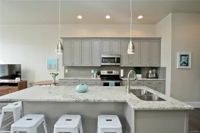 This modern kitchen has everything you need, with a spacious island that doubles as a dining table, perfect for meals, morning coffee, or catching up with friends.