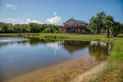Enjoy the beautiful stocked pond right outside the home! Our peaceful waterfront features a fishing pier and great views of the house and the 5-acre property. Perfect for a relaxing afternoon of fishing or enjoying the scenery.