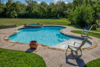 Your private escape! Dive into the crystal-clear pool or relax in the stone-clad tub. The stunning two-story home features an oversized upper deck and covered patio by the pool, surrounded by 5 acres of tranquility.