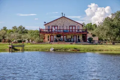 Enjoy breathtaking views of the stone-clad retreat from the edge of our stocked pond. Relax on the waterfront fishing pier or soak up the sun on the massive, two-level deck and patio overlooking the 5-acre property.