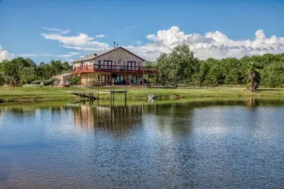 Enjoy breathtaking views of the stone-clad retreat from the edge of our stocked pond. Relax on the waterfront fishing pier or soak up the sun on the massive, two-level deck and patio overlooking the 5-acre property.