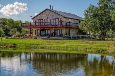 Our beautiful home boasts stunning stone-cladding, a multi-level oversized deck, and direct frontage on a stocked pond. Enjoy the spacious 5-acre property from the deck or waterfront.