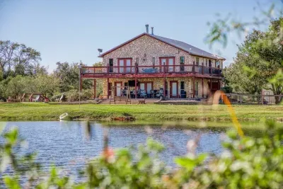 Welcome to Two Waters Retreat! Our beautiful home boasts stunning stone-cladding, a multi-level oversized deck, and direct frontage on a stocked pond. Enjoy the spacious 5-acre property from the deck or waterfront.