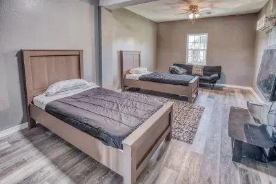 The ideal kids' room or flexible space! The fourth bedroom has two comfortable Twin beds, wood-look flooring, and a ceiling fan. The room also features a sofa/futon and a TV for extra lounging and entertainment space.