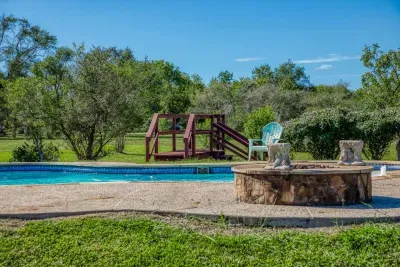 Your private escape! Dive into the crystal-clear pool or relax in the stone-clad tub. The stunning two-story home features an oversized upper deck and covered patio by the pool, surrounded by 5 acres of tranquility.