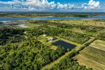Stunning aerial view! The retreat sits on 5 private acres with a stocked pond and pool, surrounded by lush greenery and water views. Enjoy the serene, coastal escape minutes from Galveston Bay.