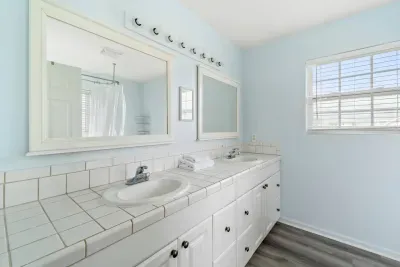 Bright full bathroom with a double vanity.