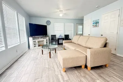 Open, airy space with tons of natural light, comfy seating, and a big TV—plus wide windows so you can enjoy coastal views from the couch.