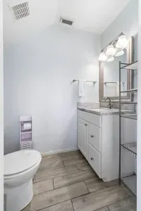 Bright bathroom with vanity, and storage space.