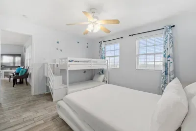Queen sized bed with two twin size bunkbeds.   Great place for a small family to rest up after a wonderful day on the beach.  Located on the main floor with the kitchen, half bath, and living room.