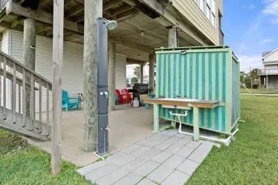 Outdoor shower for washing off the saltwater and sand from a wonderful day on the beach.  Patio also includes a sink for cleaning up after grilling out. 