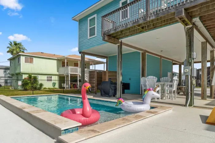 Dive into the sparkling private pool , surrounded by a paved deck perfect for sunbathing. Adjacent to the pool is a covered patio area with seating and a BBQ grill , making it the perfect spot for relaxing and enjoying the outdoors.