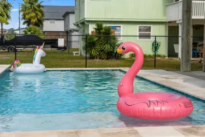 Dive into the sparkling private pool , surrounded by a paved deck perfect for sunbathing. Adjacent to the pool is a covered patio area with seating and a BBQ grill , making it the perfect spot for relaxing and enjoying the outdoors.
